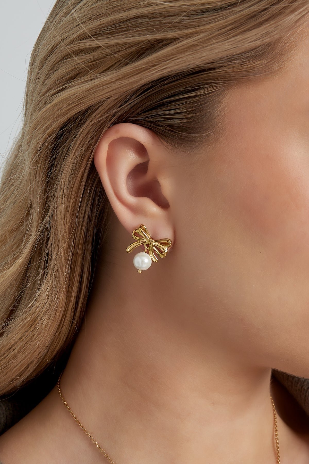 Boucles d'oreilles nœud avec perle - doré